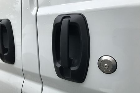 Chrome deadlock next to black van door handle